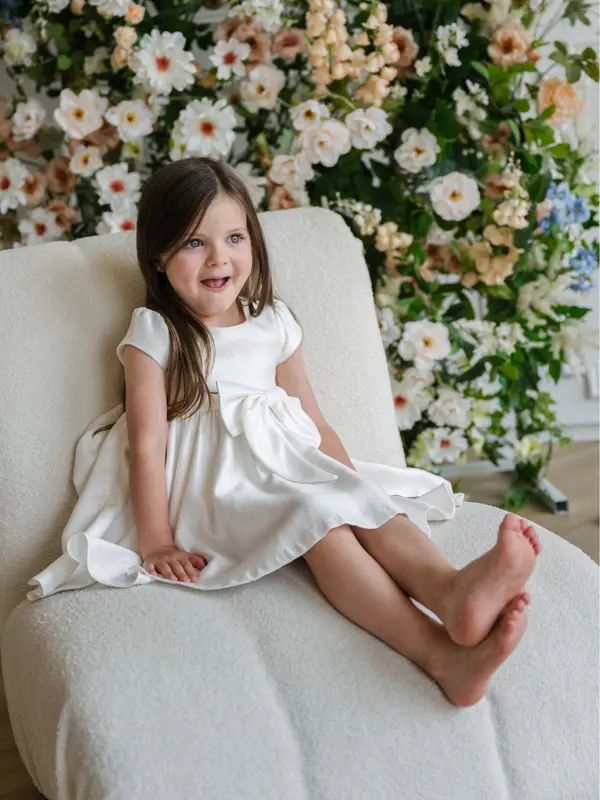 Bow-front off-white baby girl dress — Teter Warm C63 Australia